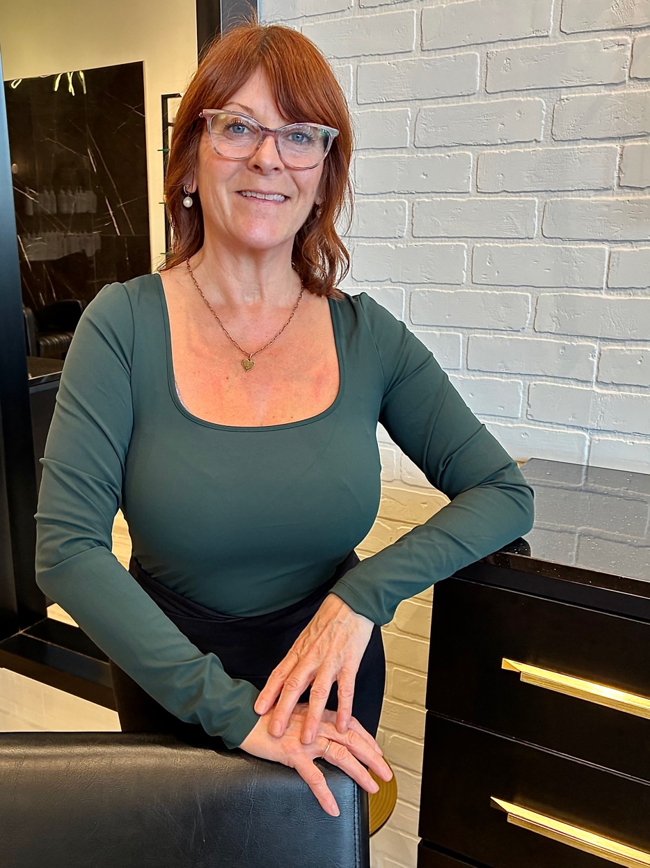 Jennifer Newell at her chair at Luxx Hair Salon